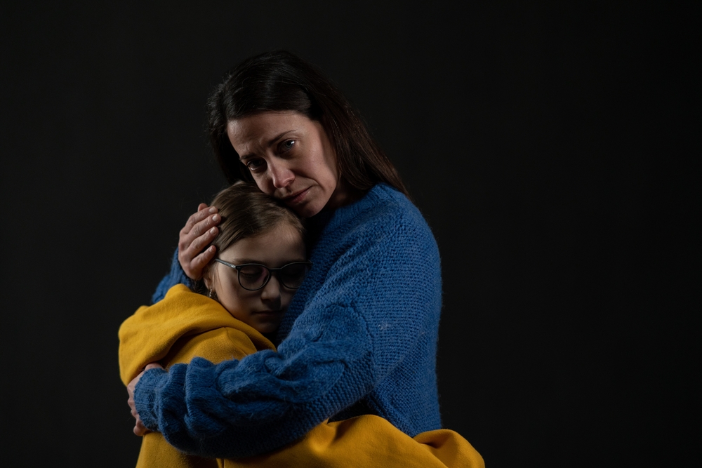Sad,Mother,Hugging,Her,Daughter,,Both,Wearing,Ukrainian,National,Colors